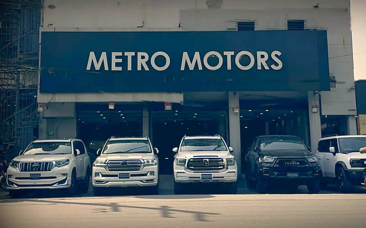 The Metro Motors showroom in Johar Town, Lahore, with SUVs parked out front